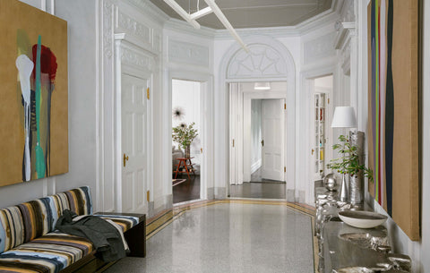 Dramatic foyer with high ceilings, art on the walls