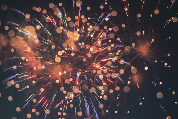 An image of fireworks in the night sky, in shades of orange, red, and blue. Photo by Erwan Hesry on Unsplash.