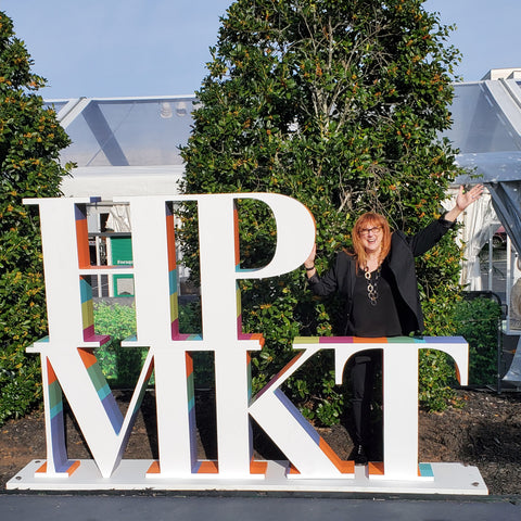 Robin Baron poses with the High Point Market Sign